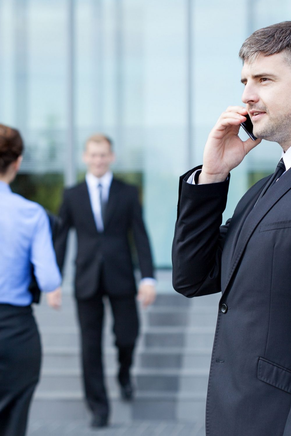 Man talking on phone in front of business centre